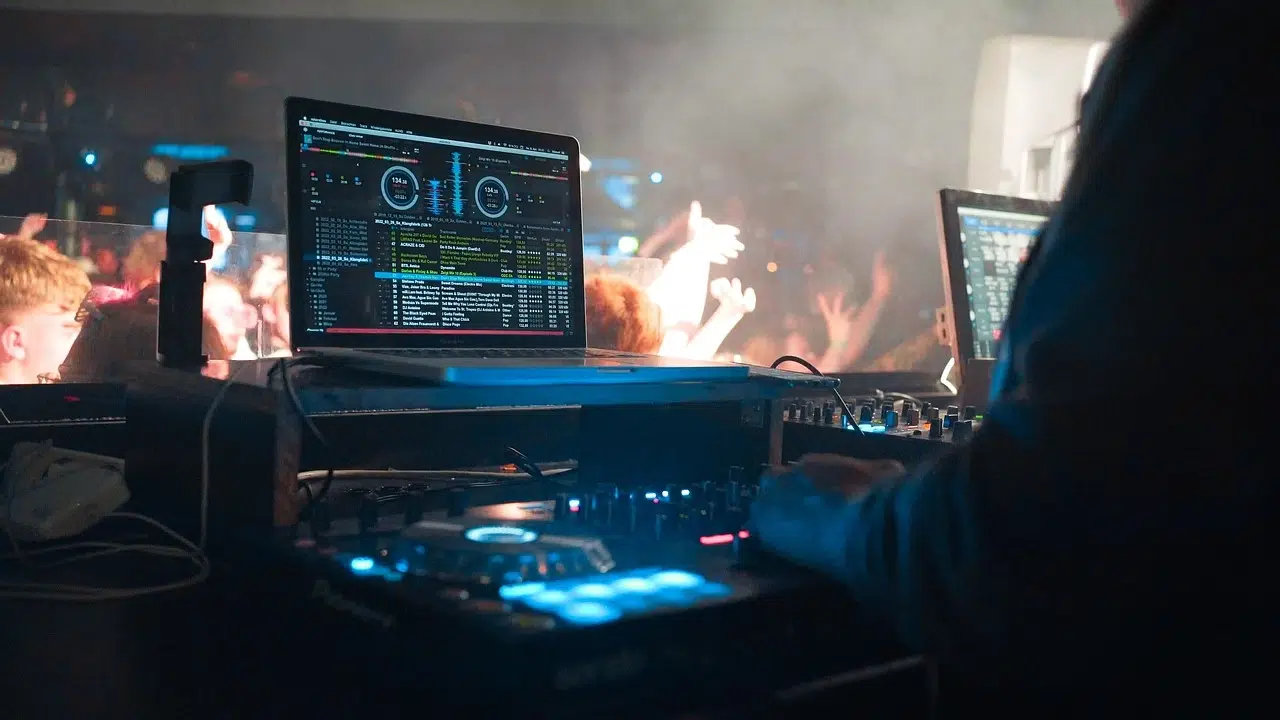 Photo of a DJ setup with laptops at a party.