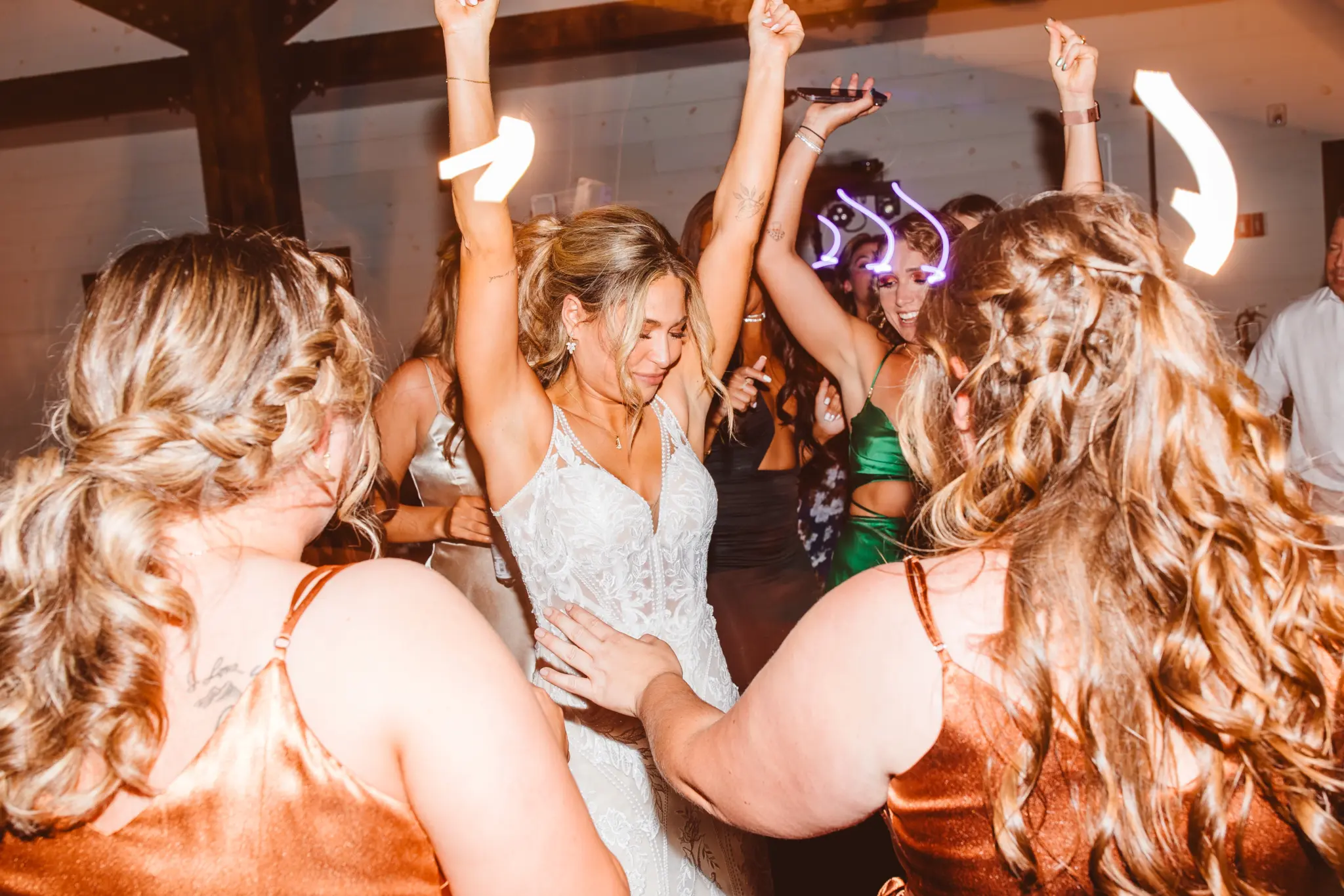 Photo of a bride dancing with girls at a wedding for wedding entertainment ideas.