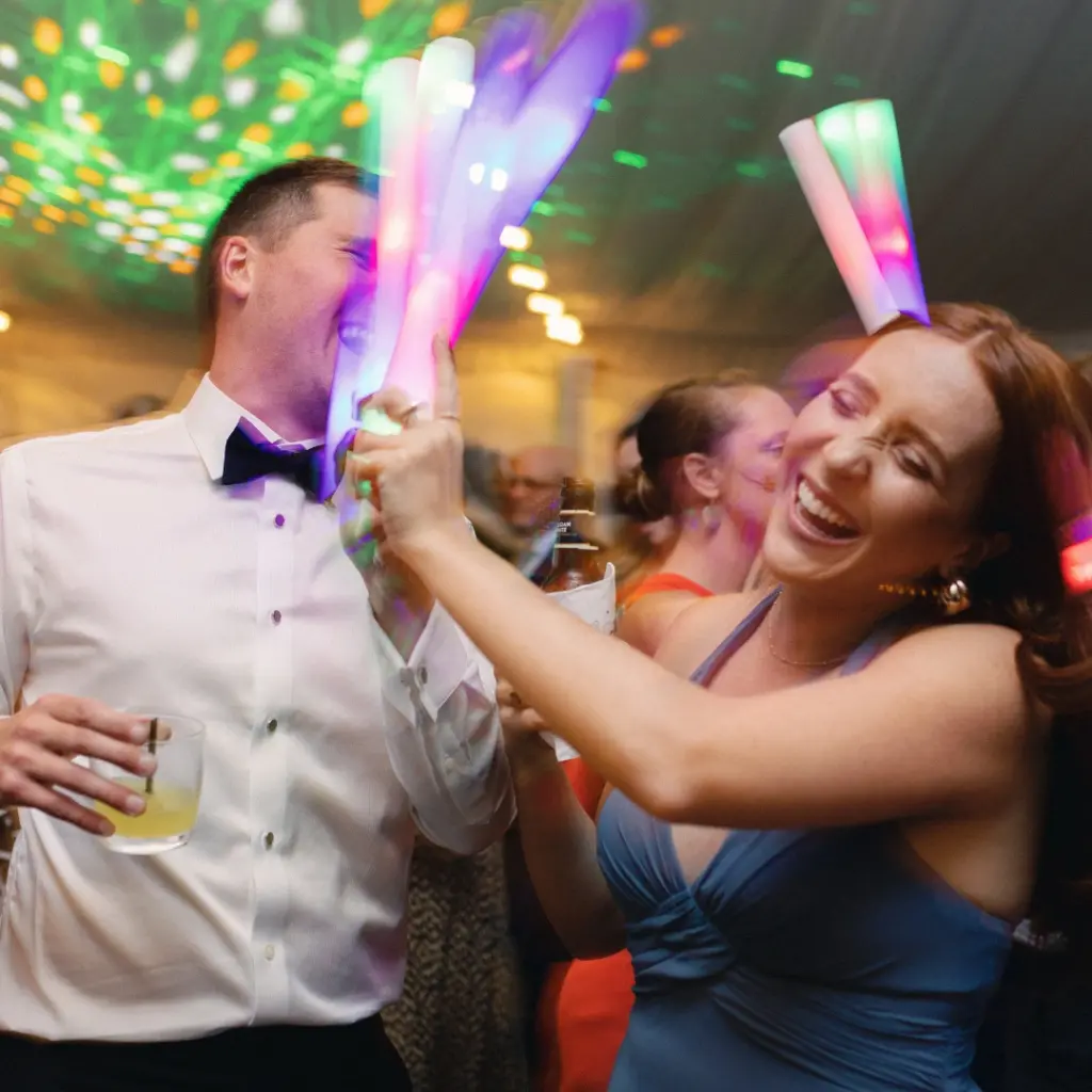Guests celebrating with colorful glowsticks.
