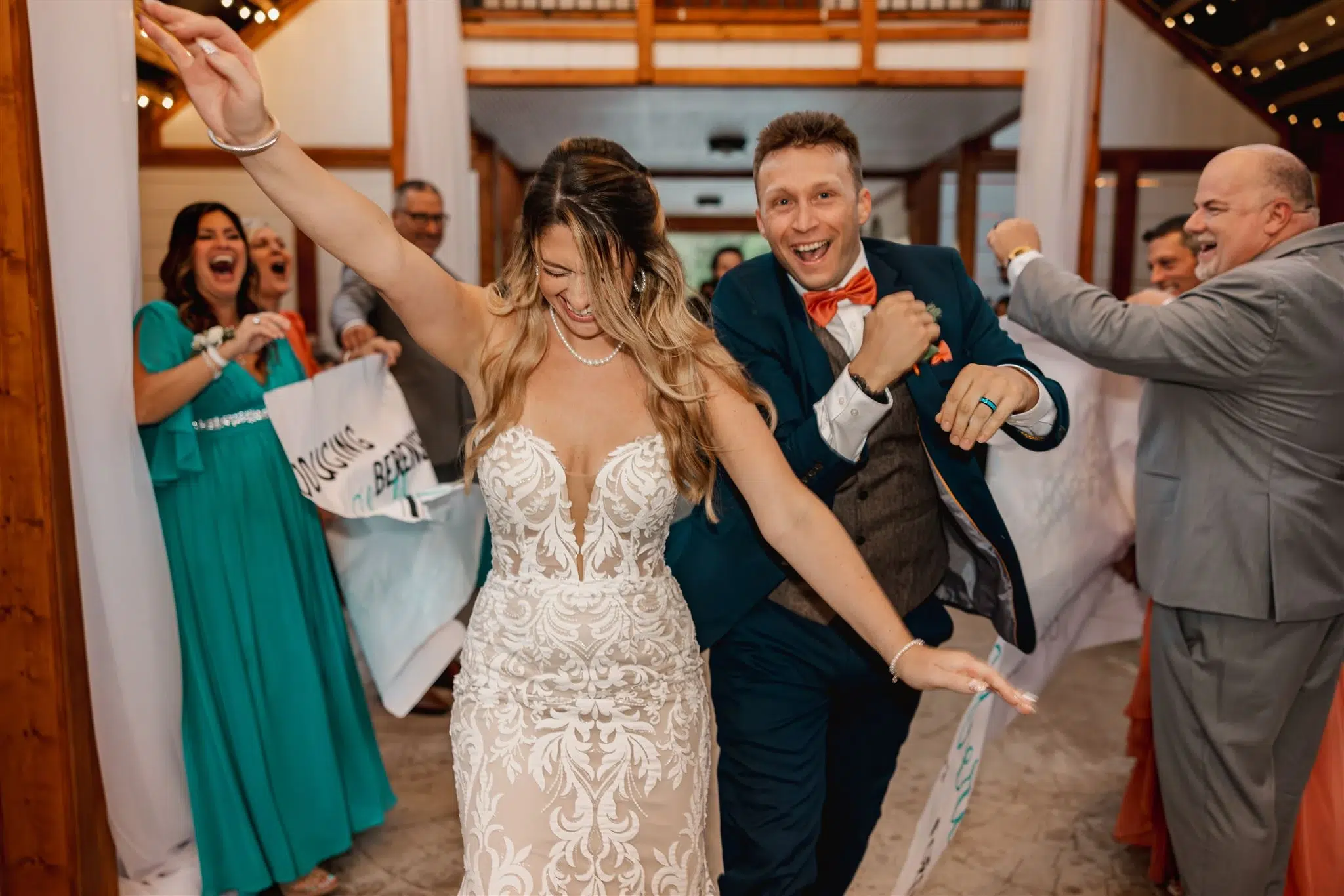 Photo of a bride and groom laughing and dancing with their guests for small wedding venues.