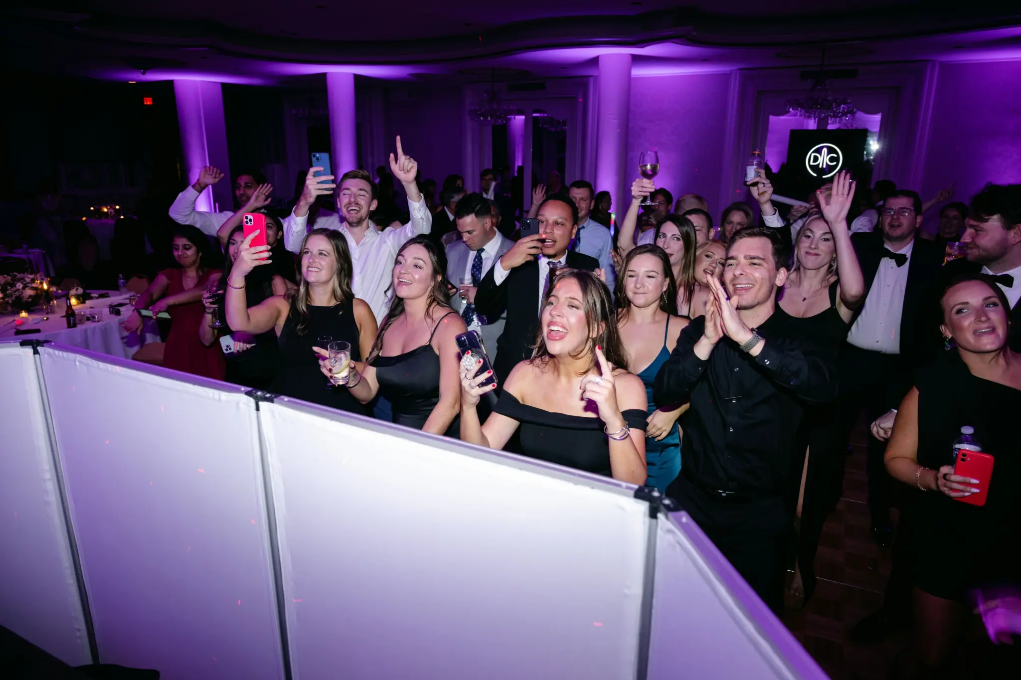 Photo of guests gathered around a DJ for Washington DC entertainment companies.