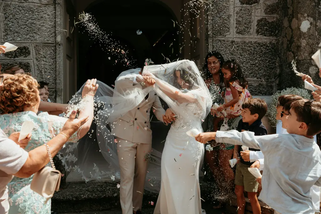 photo of kids and guests throwing flower petals at a bride and groom for wedding shower themes
