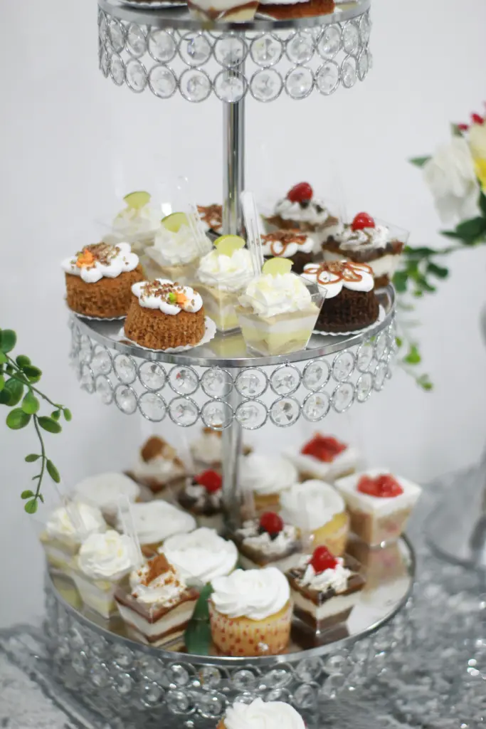 photo of mini cakes and cupcakes on a three story silver cake stand for wedding shower themes