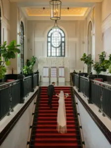 photo-of-a-bride-and-groom-climbing-the-stairs-at-the-venue-for-how-much-does-a-venue-for-a-wedding-cost