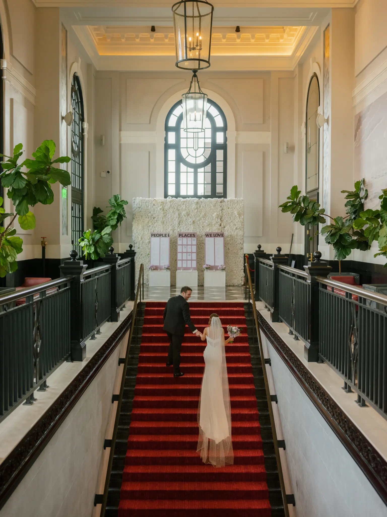 photo-of-a-bride-and-groom-climbing-the-stairs-at-the-venue-for-how-much-does-a-venue-for-a-wedding-cost