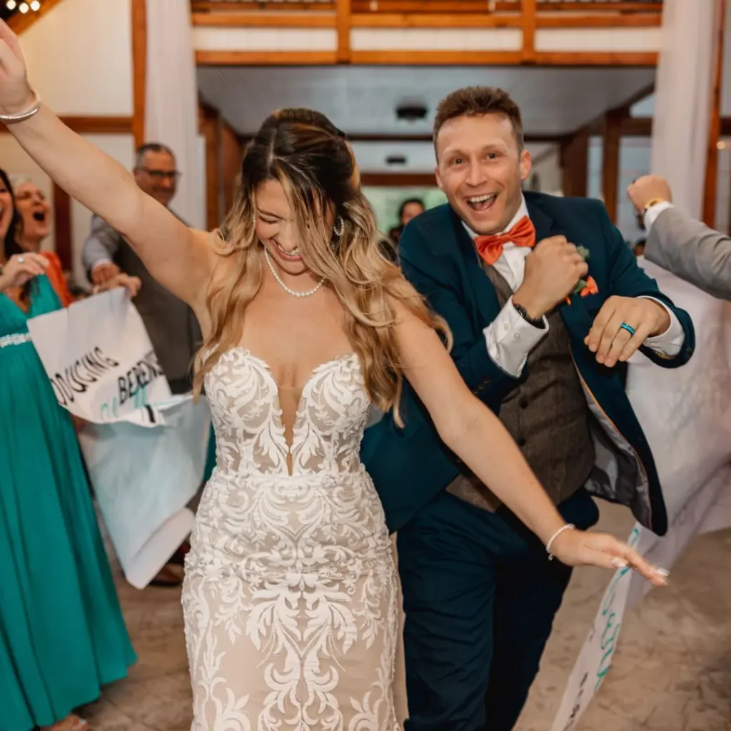 photo-of-a-bride-and-groom-laughing-while-walking-down-the-aisle-for-wedding-party-entrance-ideas