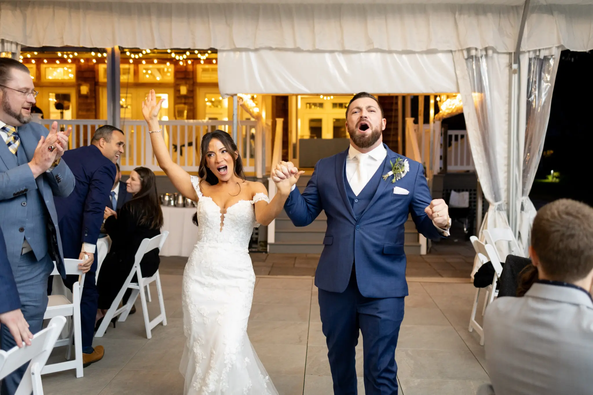 photo of a bride and groom dancing with their guests while they wave glowsticks for dj columbia