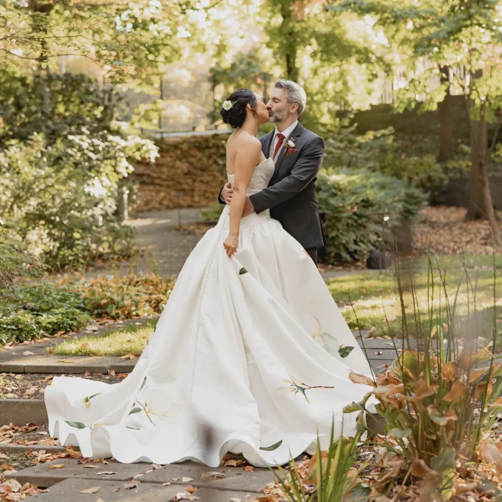 photo of a bride and groom kissing in a garden for ideas for wedding venues