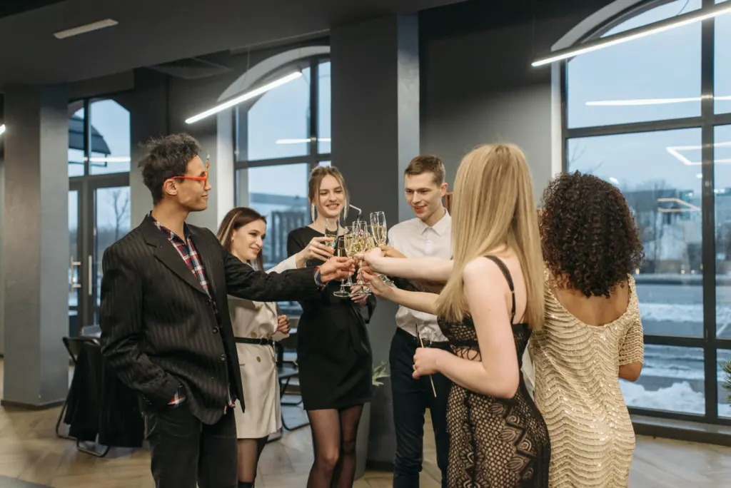photo of a group of people raising a toast with champagne glasses