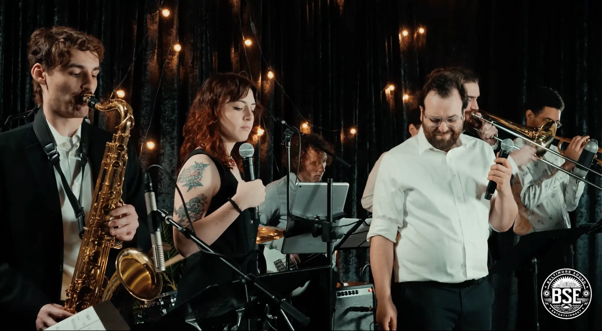 Photo of a live band performing at an event on stage by Baltimore Sound Entertainment.