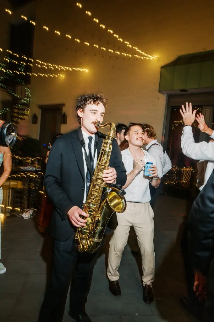 Photo of a man playing a saxophone at a party for live music for corporate events.