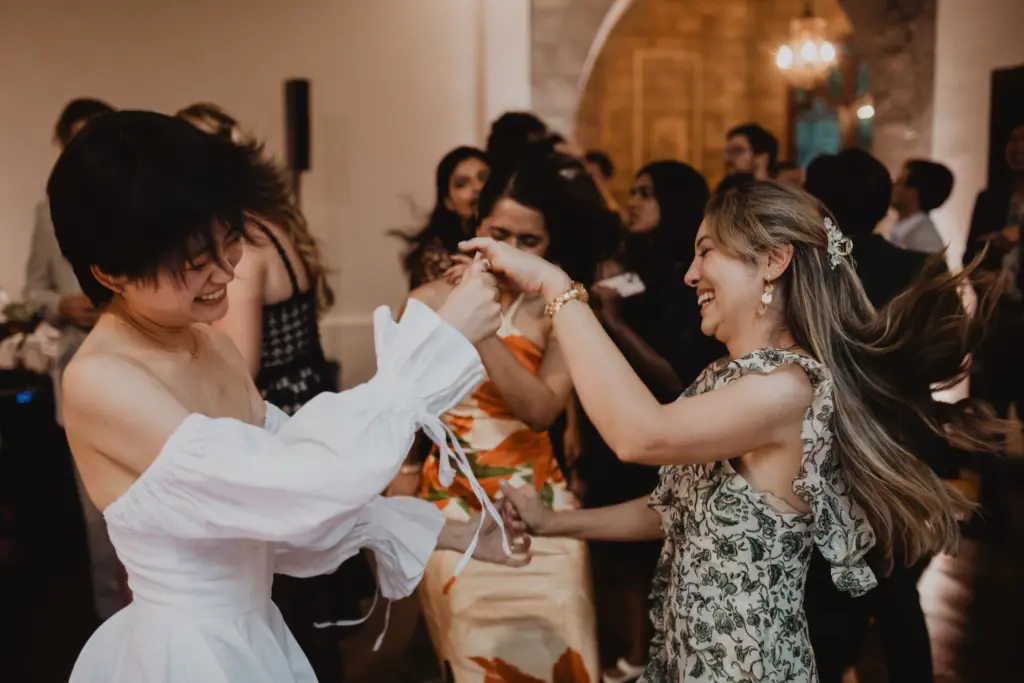photo of girls dancing with a bride at her wedding for how much to rent a dance floor