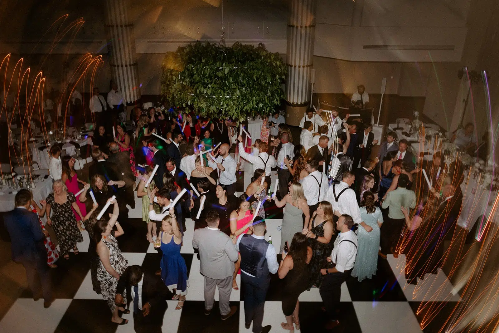 photo of guests at a wedding dancing on the dance floor with glowsticks for dj york pa