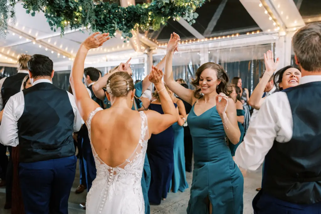 photo bride and guests dancing to live musicians for a wedding reception
