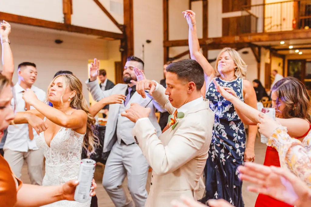 photo of a bride and groom dancing with their guests at the wedding reception