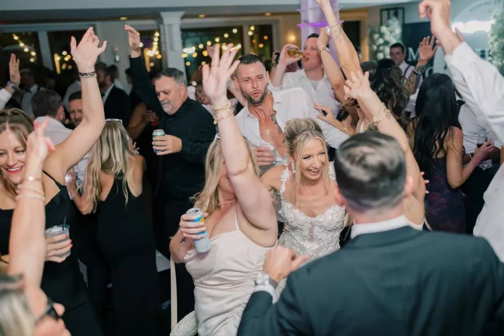 photo of a bride dancing with her guests at her wedding for wedding reception bands