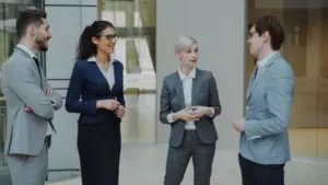 photo-of-four-people-in-suits-talking-at-a-networking-event