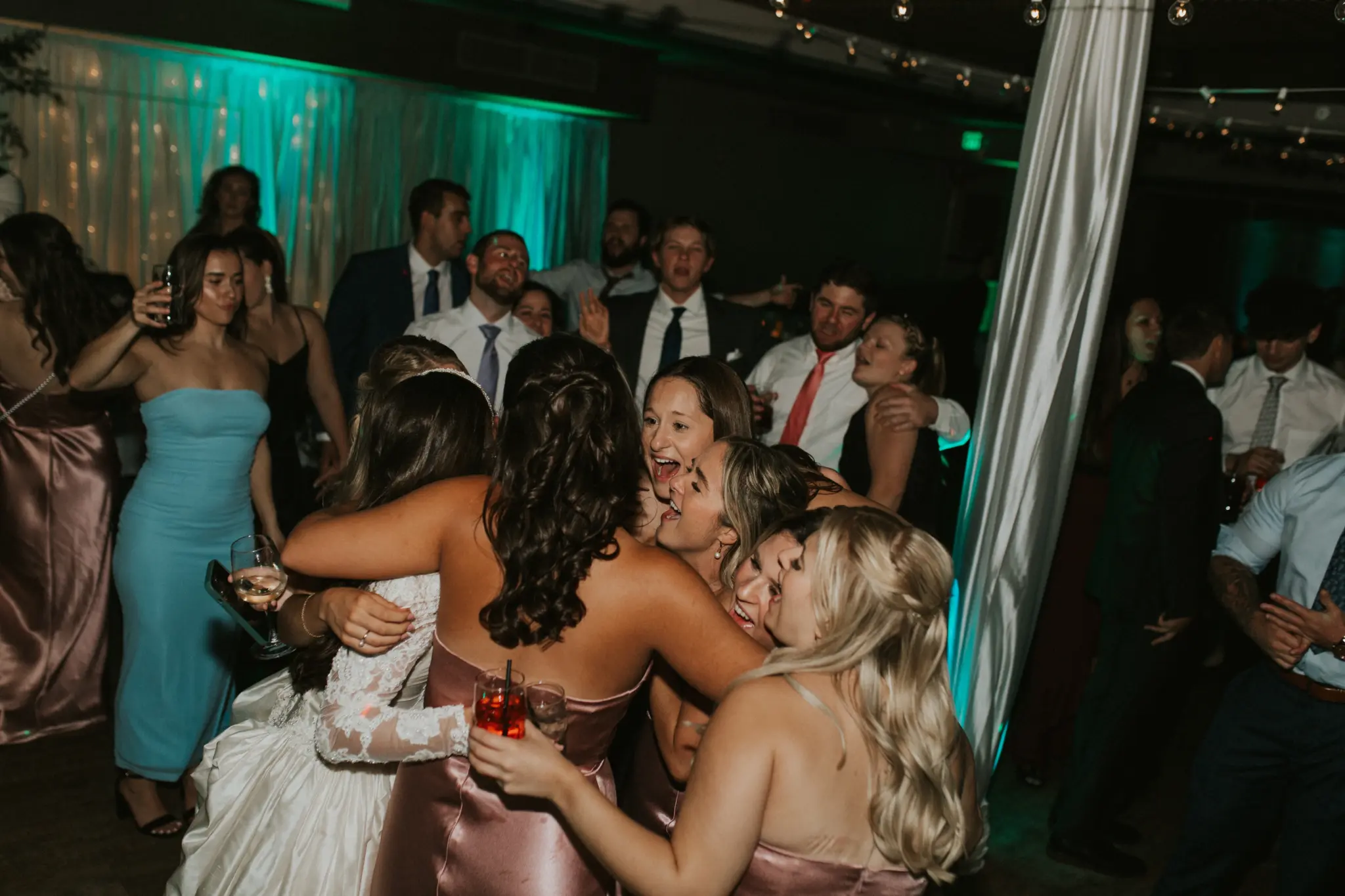 photo-of-girls-huddled-around-a-bride-and-dancing-for-event-production-arlington