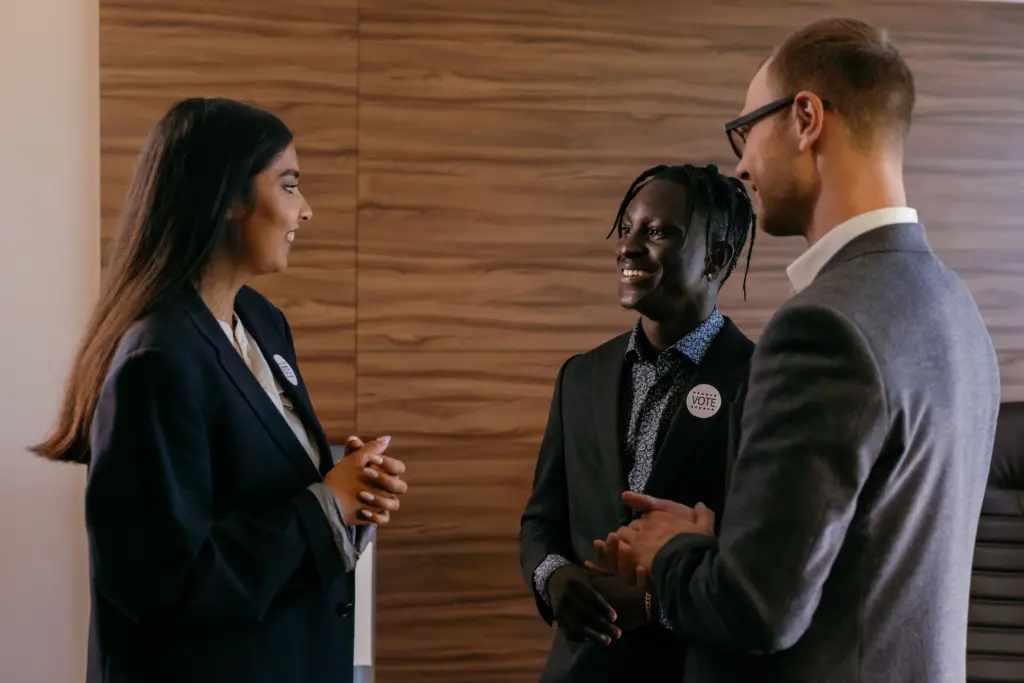 photo-of-three-people-in-suits-talking-for-corporate-networking-event-ideas