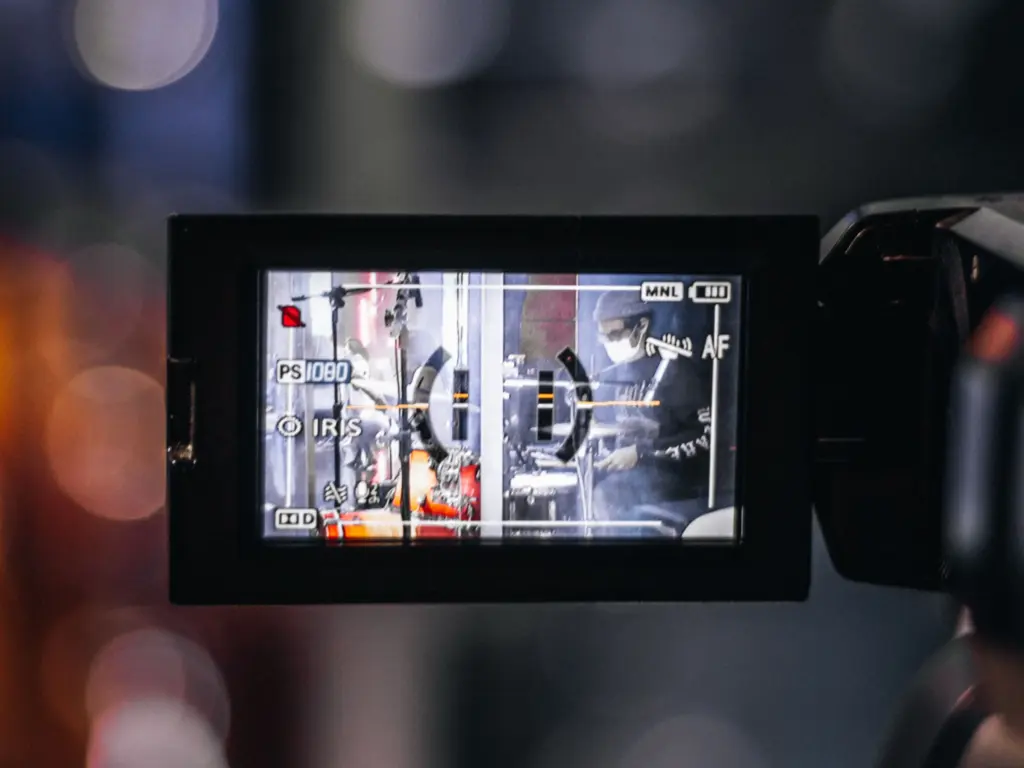 photo of a video camera recording a music event