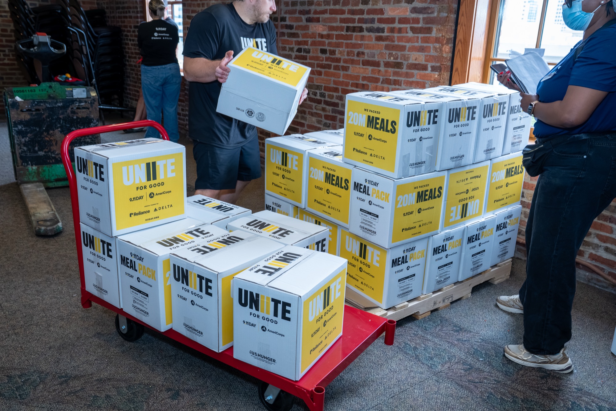 Cases of packed meals stacked on carts