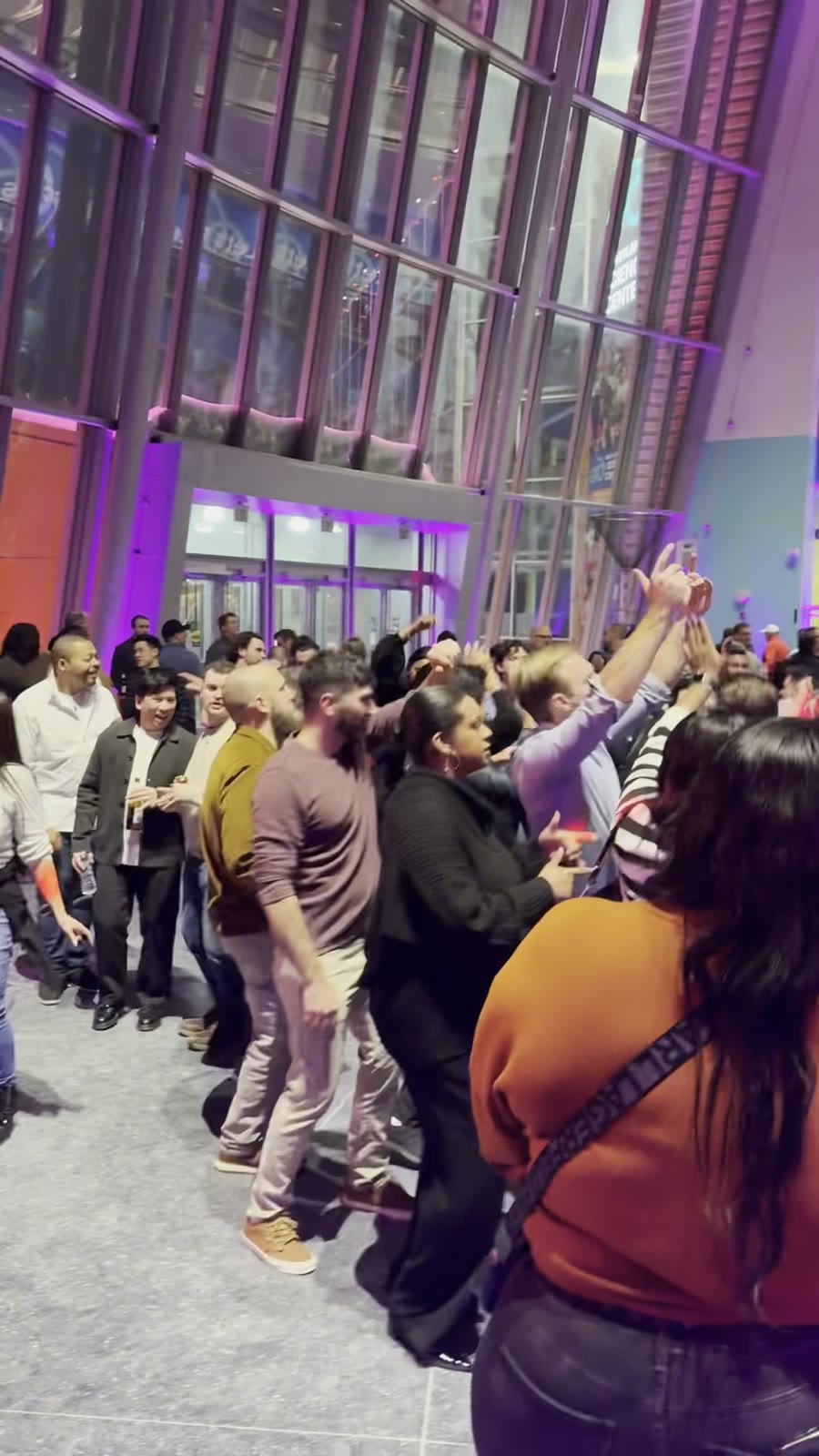 Hilti guests dancing with hands up on a packed floor at the Maryland Science Center