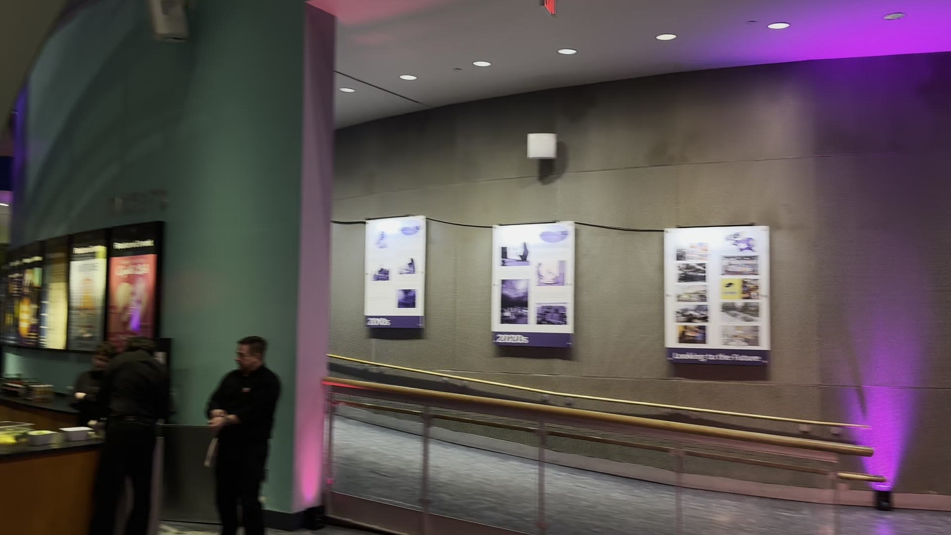 Battery-powered purple uplights washing a gallery wall at the Maryland Science Center
