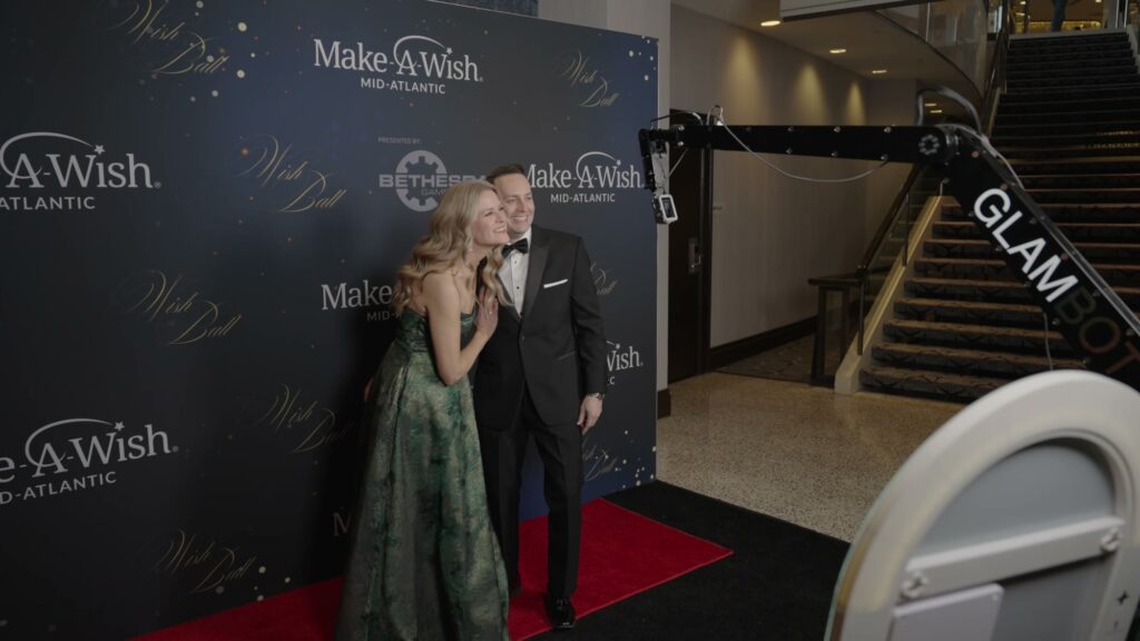 Couple on the Make-A-Wish red carpet with the Glambot camera arm