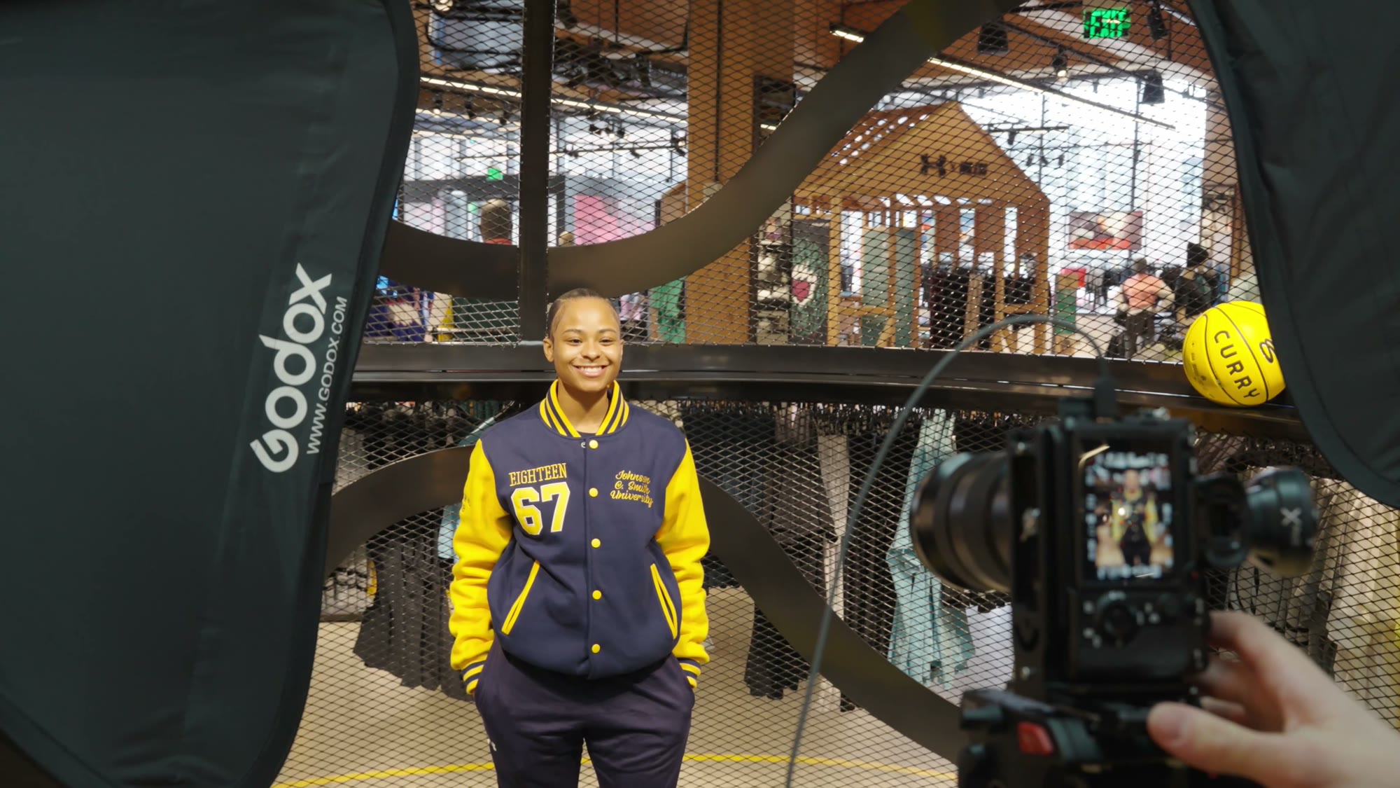Guest in a letterman jacket posing for a CIAA player card